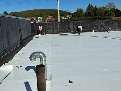 Meadow Springs crew installing a single ply membrane roof on a commercial building