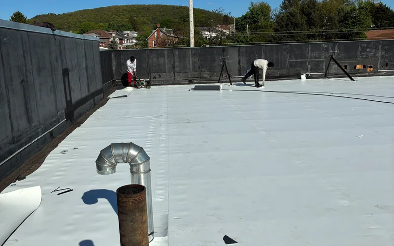 Meadow Springs crew installing a single ply membrane roof on a commercial building