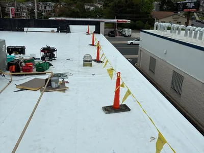 New white membrane roof being installed on a commercial building in Pennsylvania