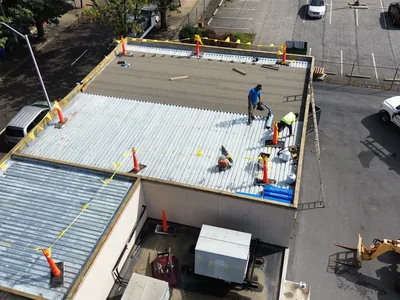 Meadow Springs crew preparing a commercial metal roof for restoration