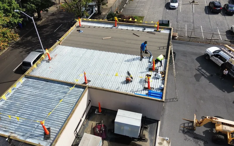 Meadow Springs crew preparing a commercial metal roof for restoration