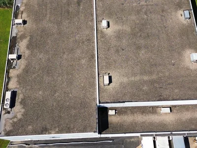 Aged commercial flat roof before a fabric reinforced system was applied