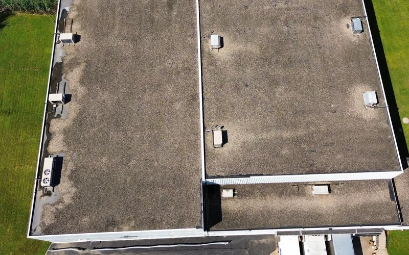 Aged commercial flat roof before a fabric reinforced system was applied