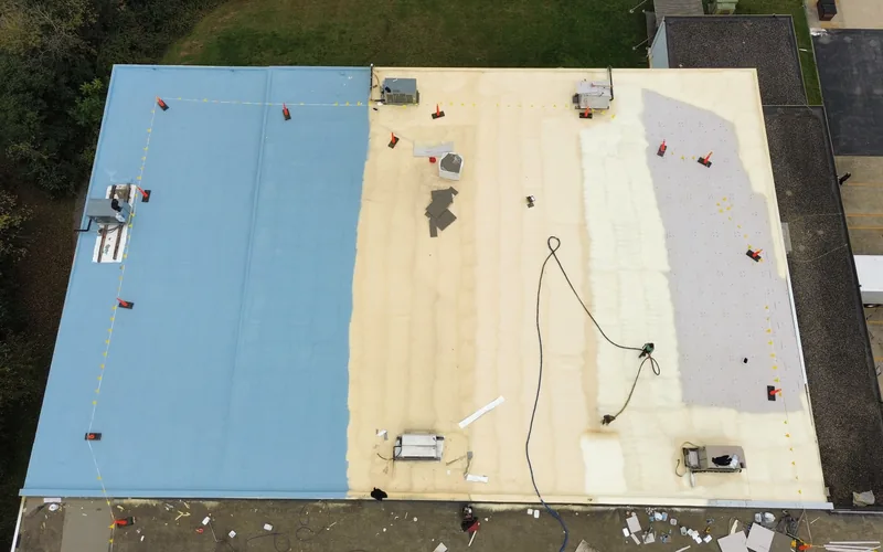 Commercial roof restoration in progress showing the base, foam and finish coat stages