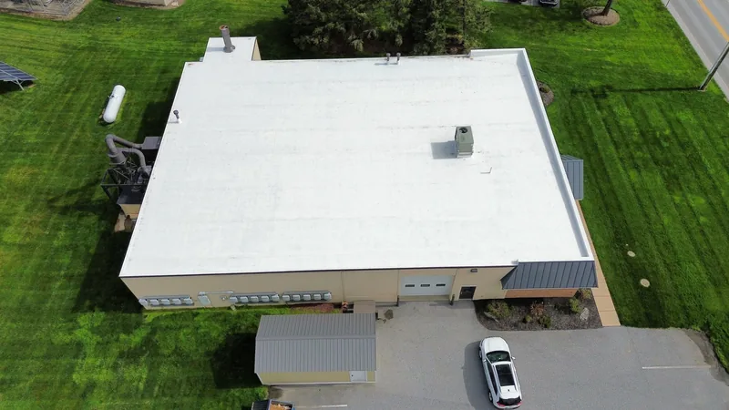 Completed white commercial roof restoration on a Pennsylvania warehouse