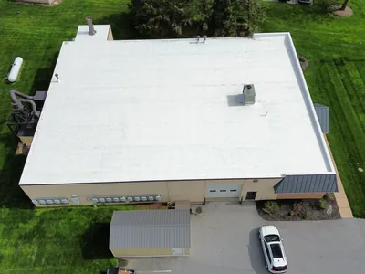 Completed white commercial roof restoration on a Pennsylvania warehouse