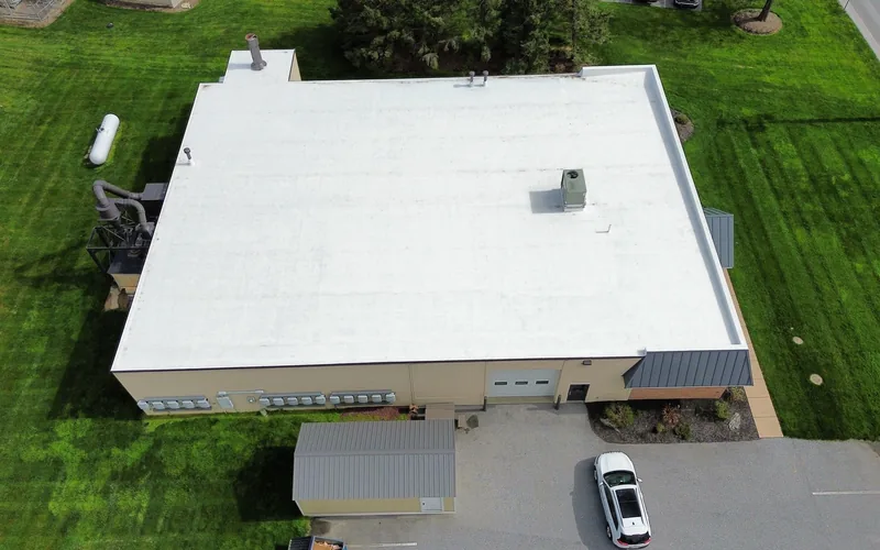 Completed white commercial roof restoration on a Pennsylvania warehouse